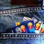Close-up of a denim pocket with multiple credit cards, illustrating finance and fashion.