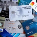 Close-up image of various credit and debit cards including Visa, MasterCard, American Express, and Discover.